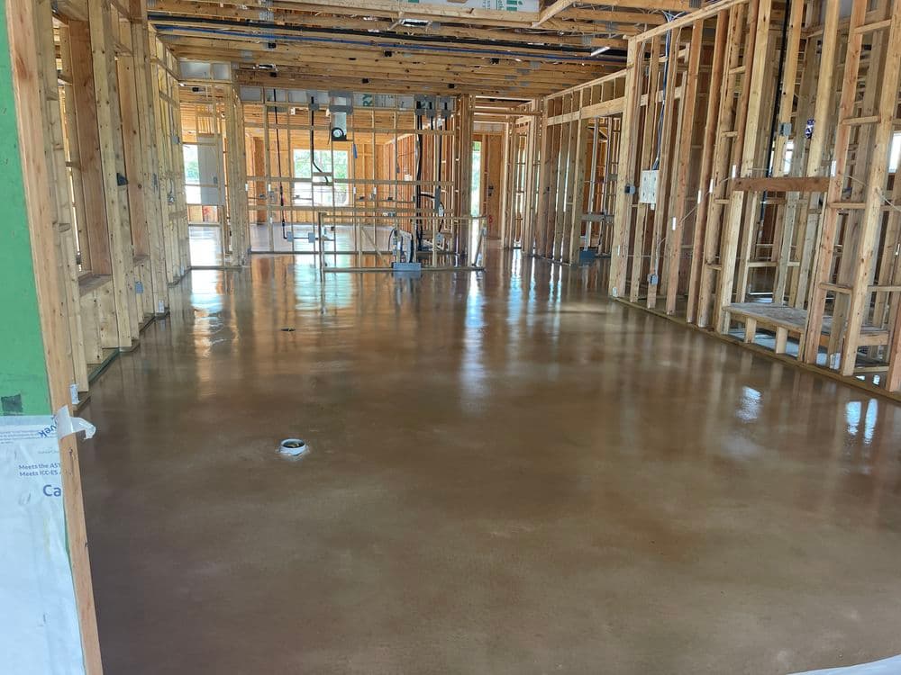 Newly built home interior with polished concrete floor and wooden framing.